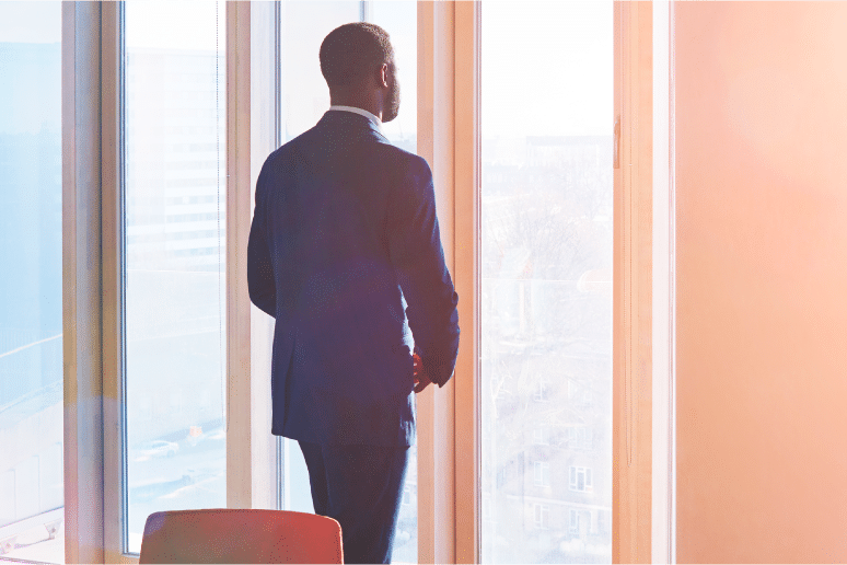 man looking out window