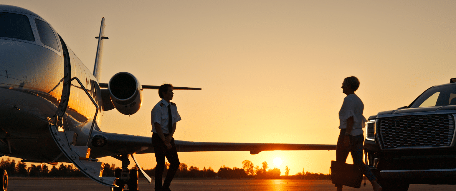Individual walking towards pilot and private plane.